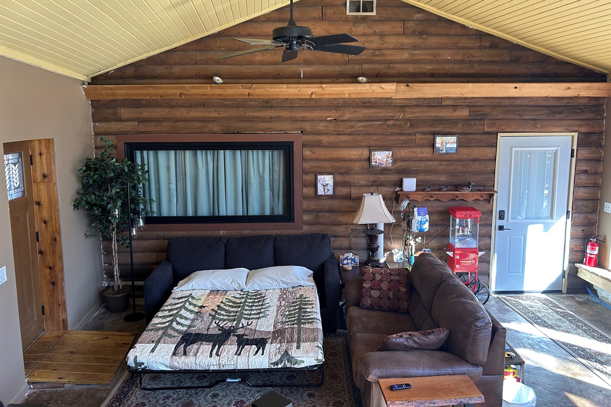 Looking down into Sunroom at open sofa bed.