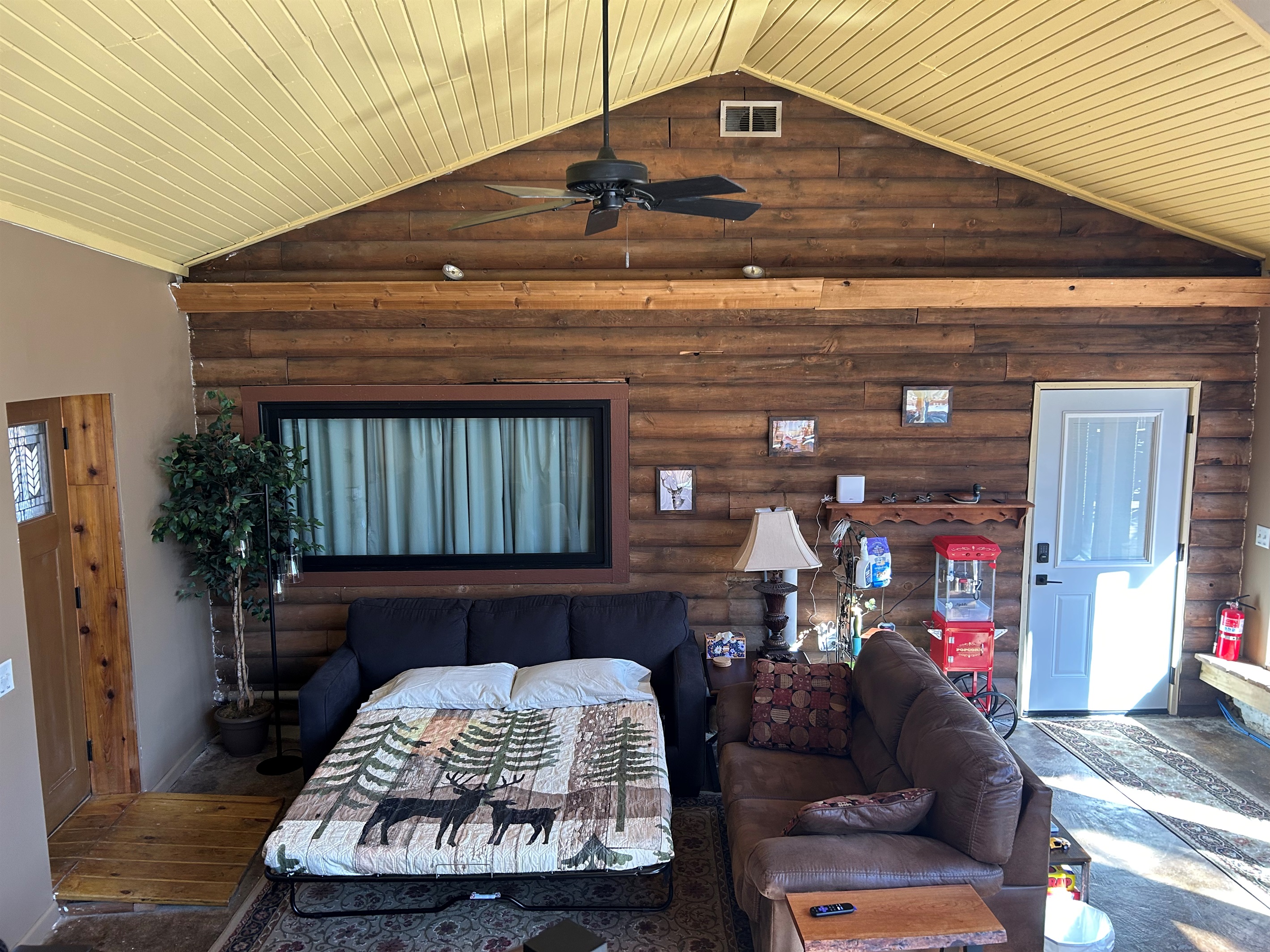 Looking down into Sunroom at open sofa bed.