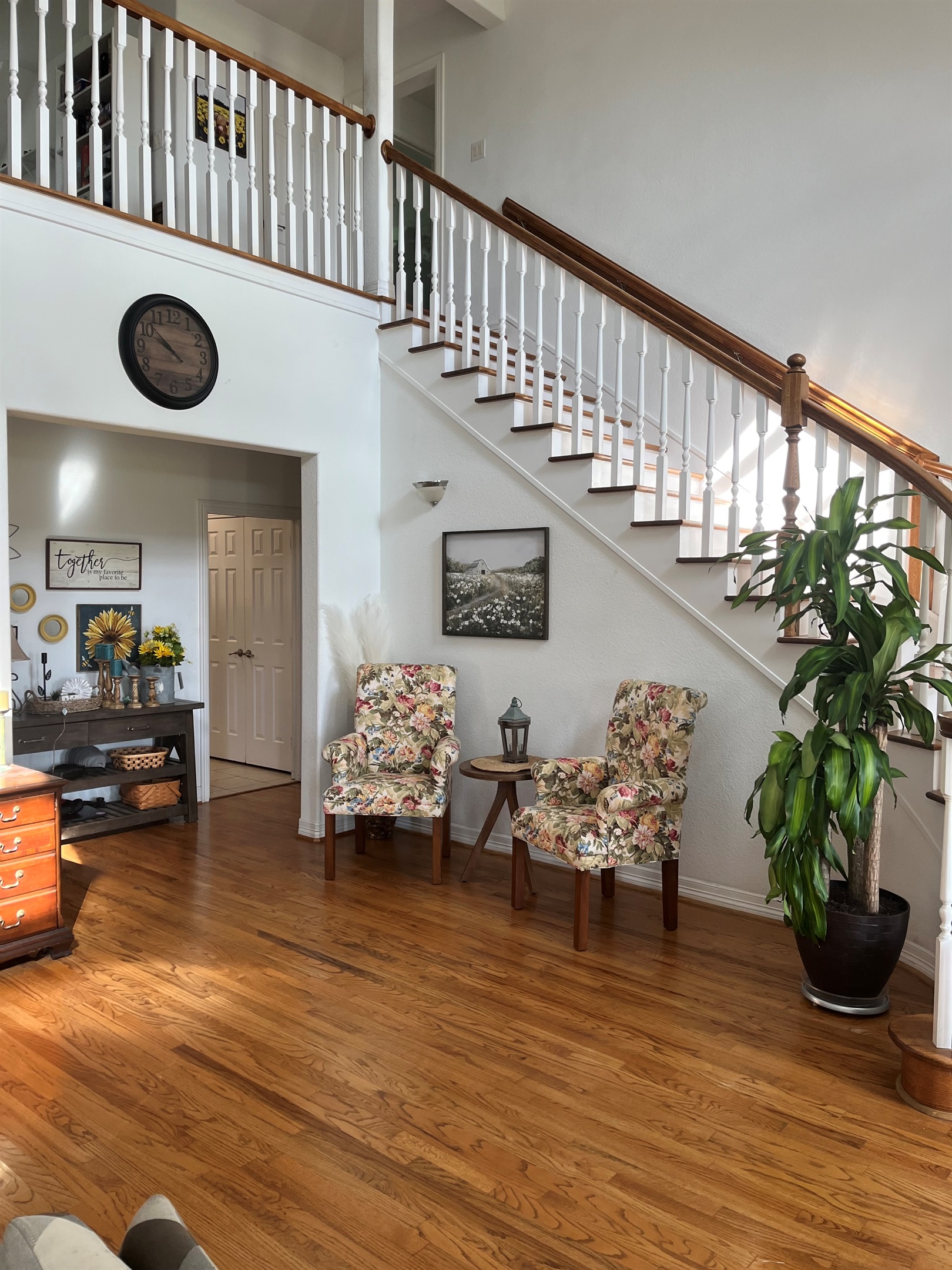 Beautiful curved staircase with enormous 21ft ceiling.