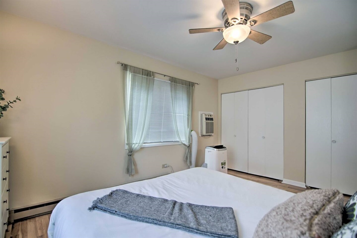 The master bedroom has a queen size bed, window AC, and ceiling fan for your sleeping comfort. Beach towels, a Pack-N-Play, an iron, and a full-size ironing board are also supplied.