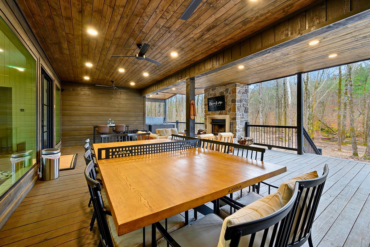 A long dining table under the covered deck gives your group plenty of room for shared meals outside.