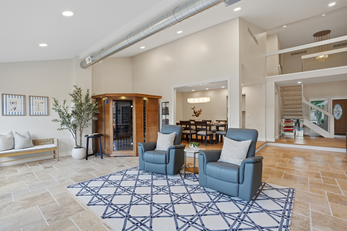 Relax in this spacious indoor pool lounge featuring a private sauna, soaring ceilings, and comfortable seating areas. The open-concept design creates the perfect space to unwind, gather with family and friends, or enjoy a luxury resort-style experience 