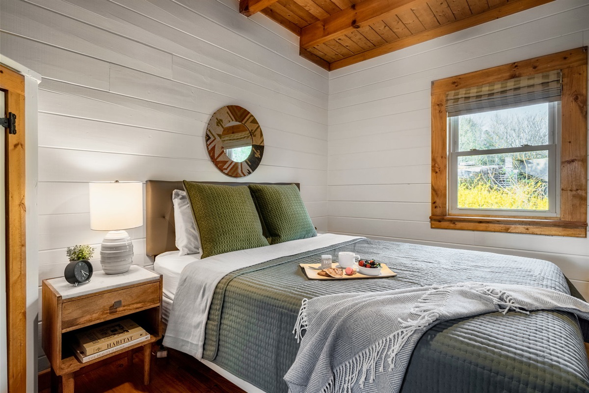 Escape to serenity in our charming cabin bedroom, complete with a cozy bed that promises sweet dreams and restful nights. Your perfect retreat awaits!
