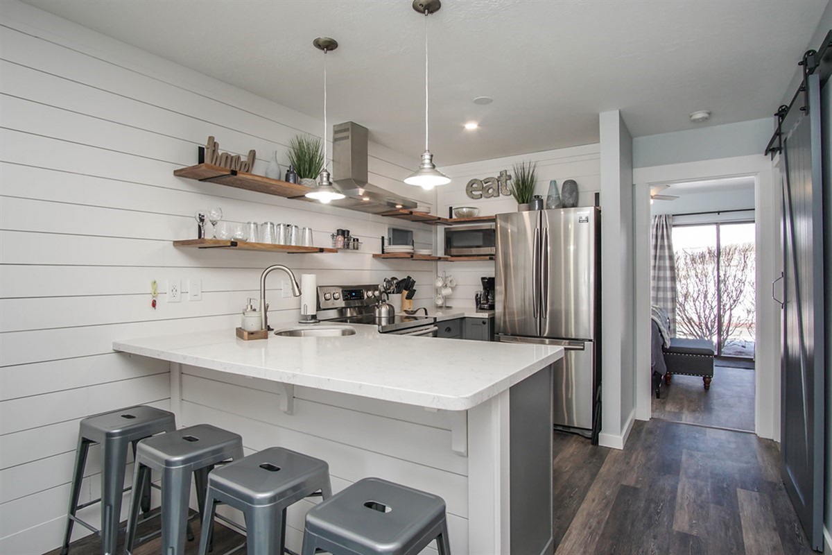 Modern kitchen with bar seating—perfect for morning coffee or casual meals.
