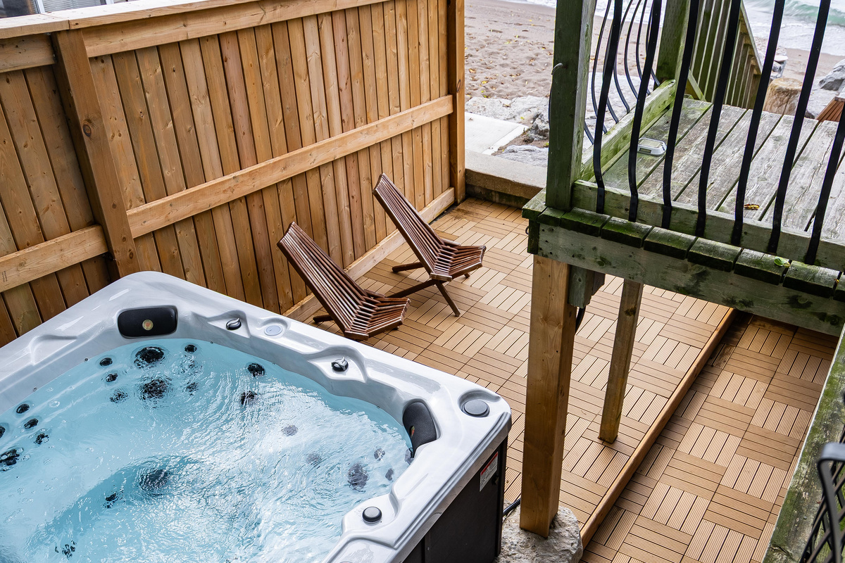 Outdoor hot tub with private deck seating