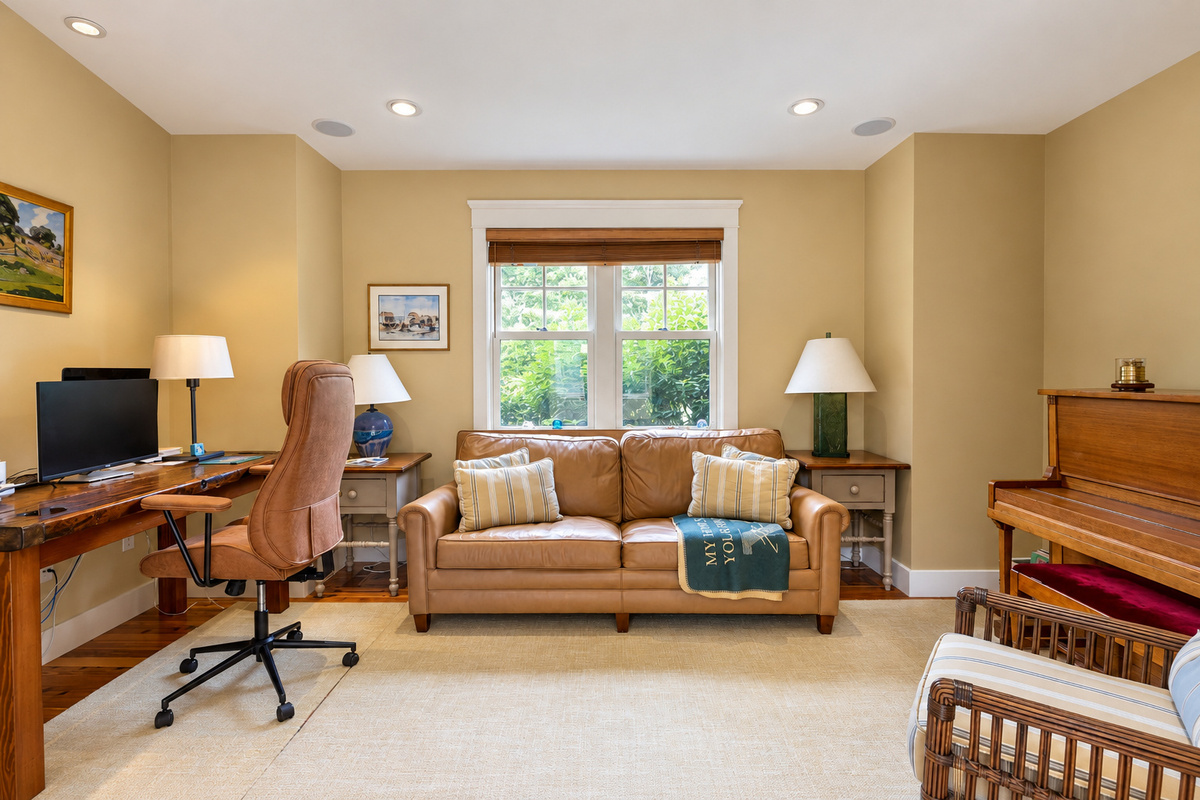 Den with desk, sofa, and piano