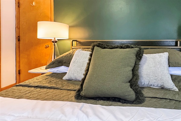 Sleep soundly in this serene space featuring premium linens and soft velvet accents.