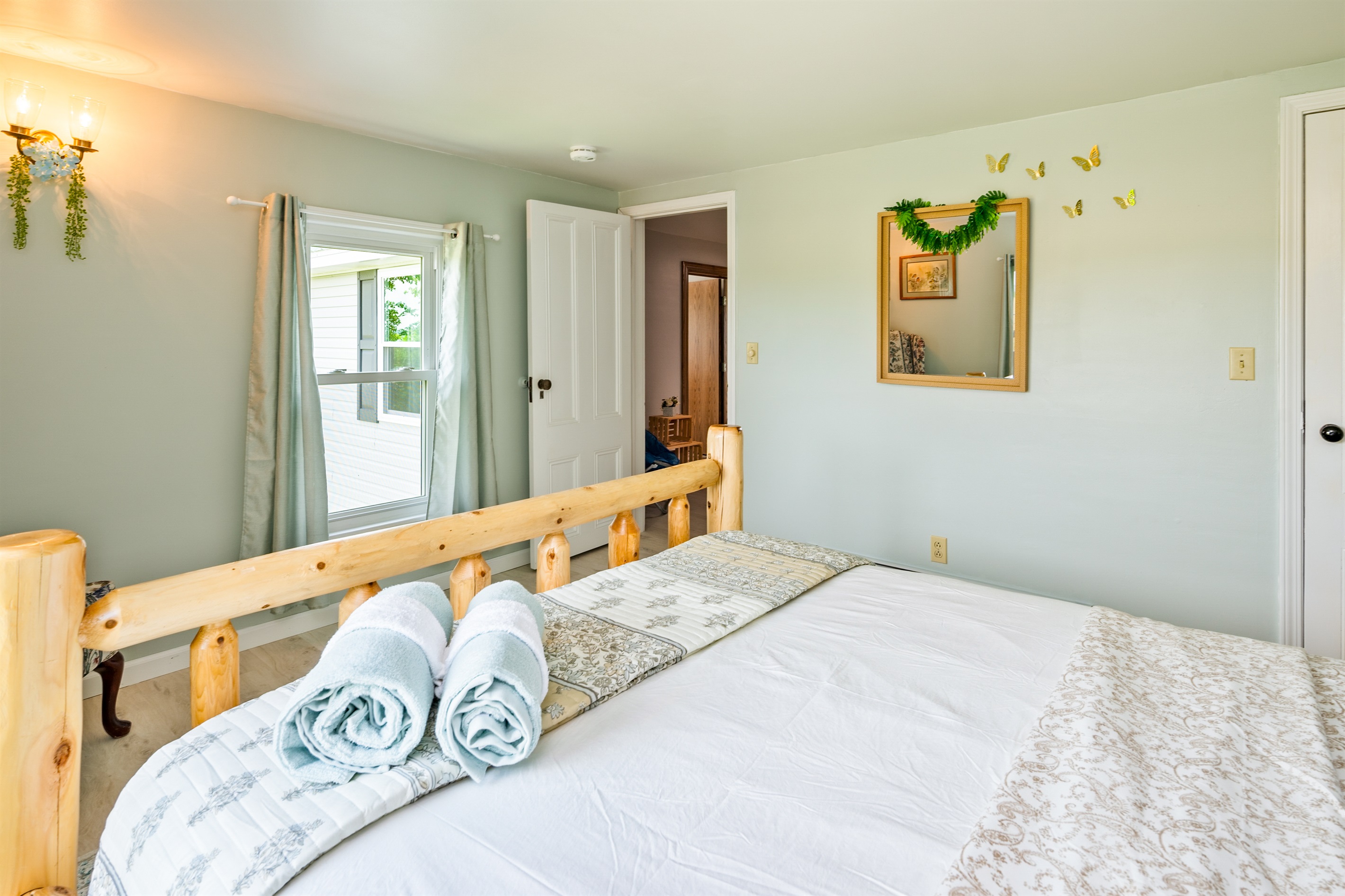 Relax in this beautifully furnished log-frame bed with peaceful views and cozy cottage charm.