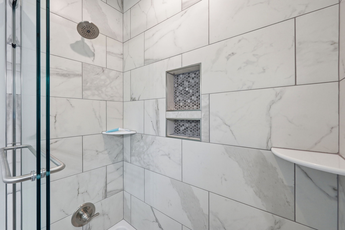 Thoughtfully designed with premium finishes and a spacious walk-in shower, this full bathroom combines comfort and style for your stay