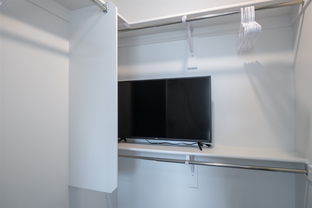 TV tucked neatly in the closet for flexible bedroom layout.