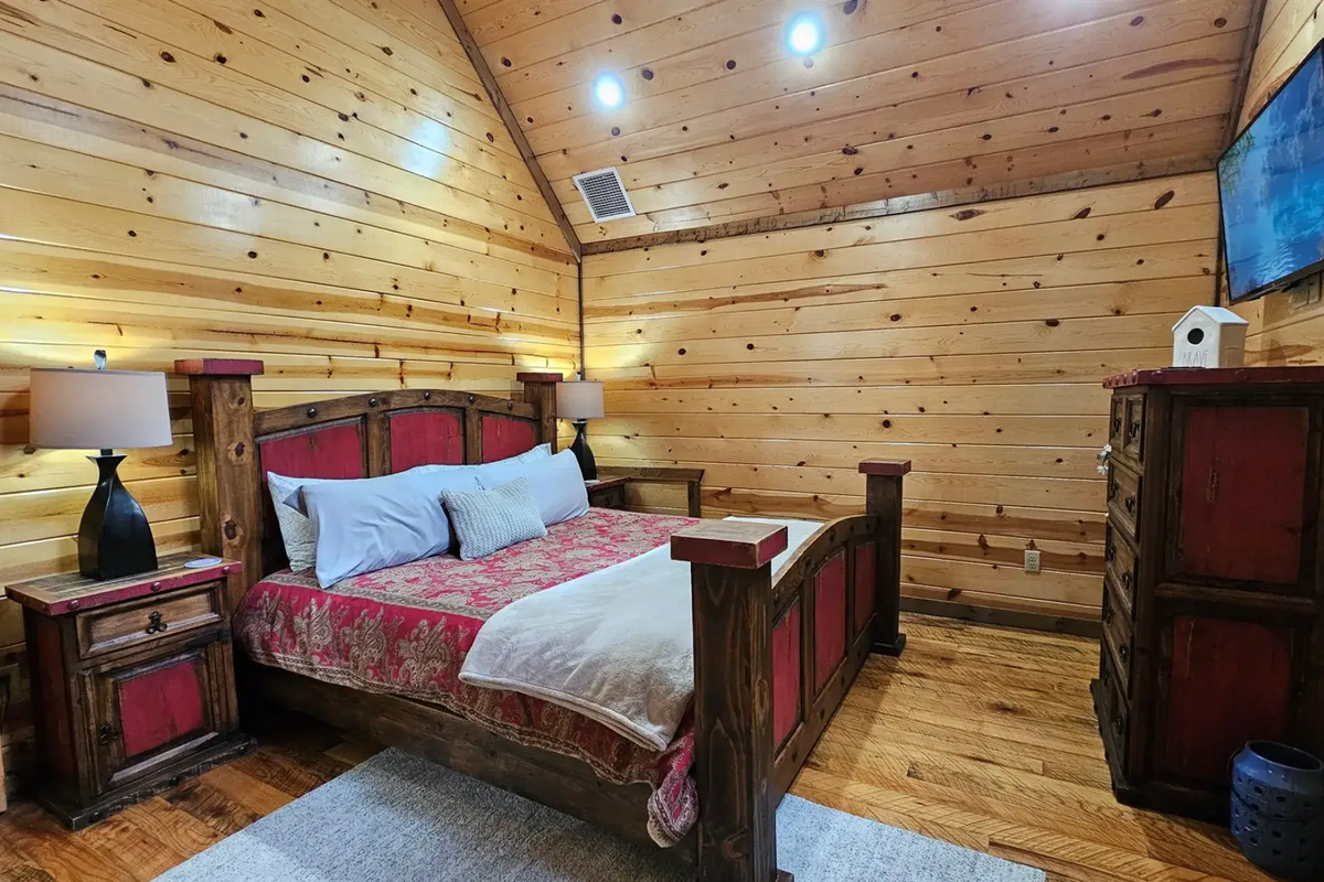 Bedroom 3: Rustic charm meets modern comfort with stunning wood accents and a serene view!