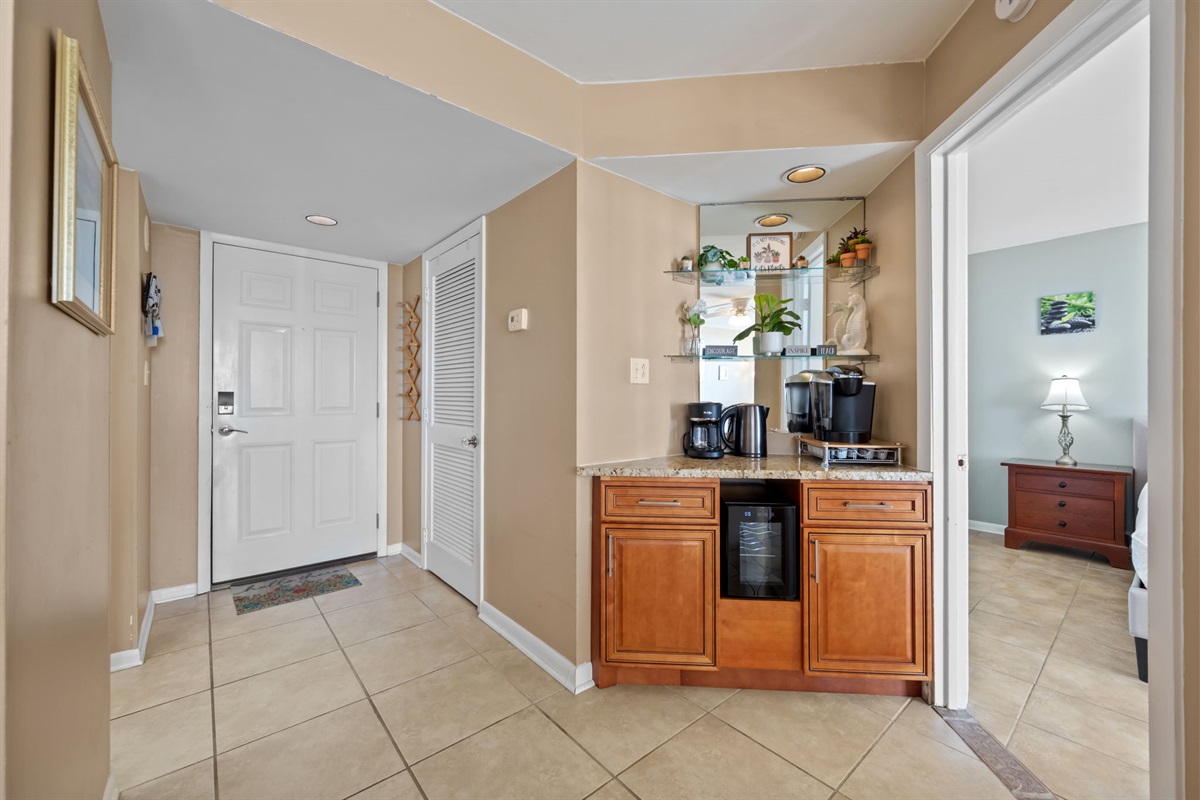Entryway with easy access to the coffee station and quick flow into the bedroom, kitchen, and main living areas