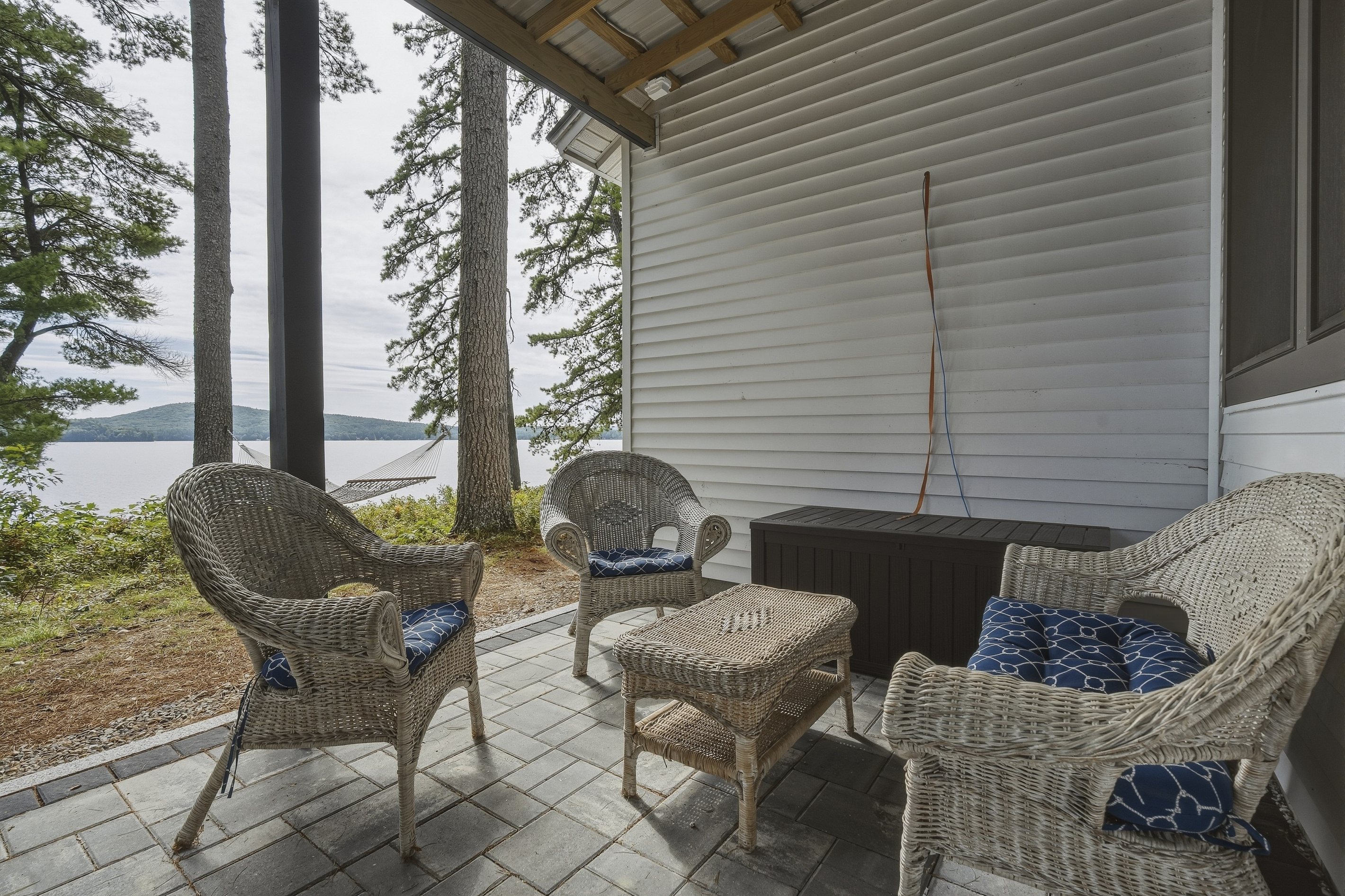 Rainy afternoon or crisp evening, this sheltered outdoor nook keeps the lake-house relaxation going.