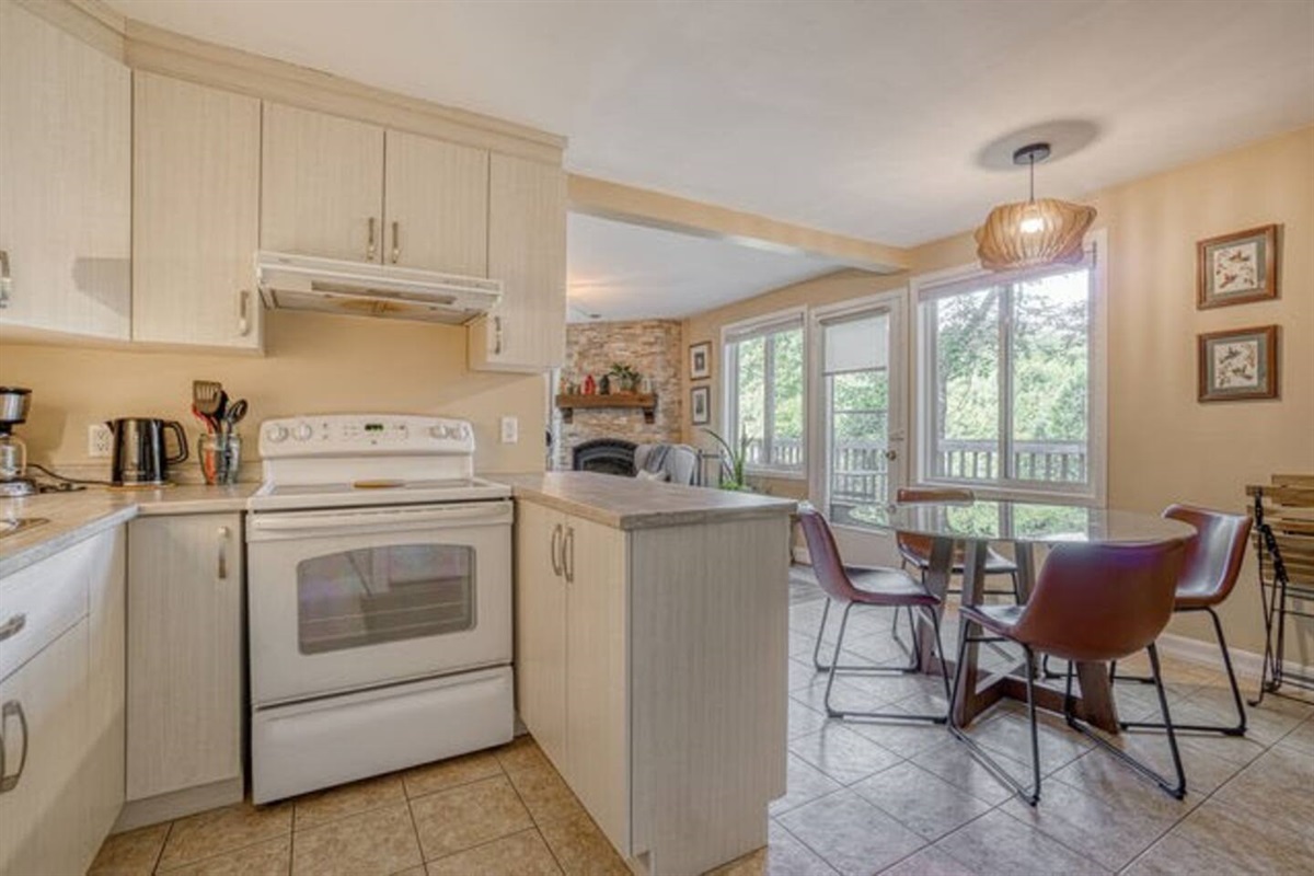 View from kitchen toward dining area showing access doors to balcony