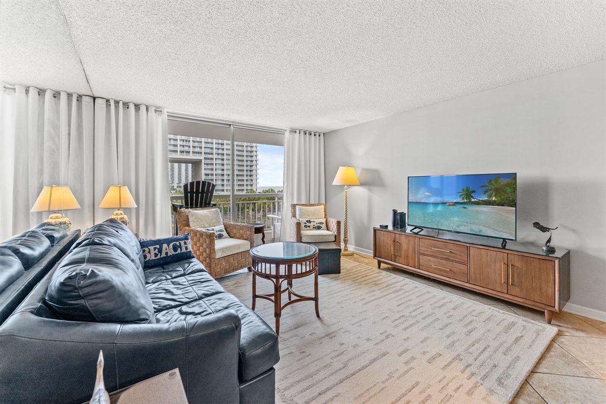 Spacious Living Room  with large TV and balcony access
