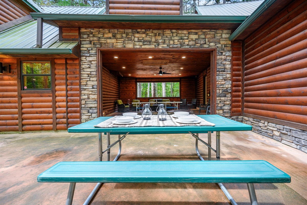Picnic table sits outside of the breezeway to enjoy outdoor meals.