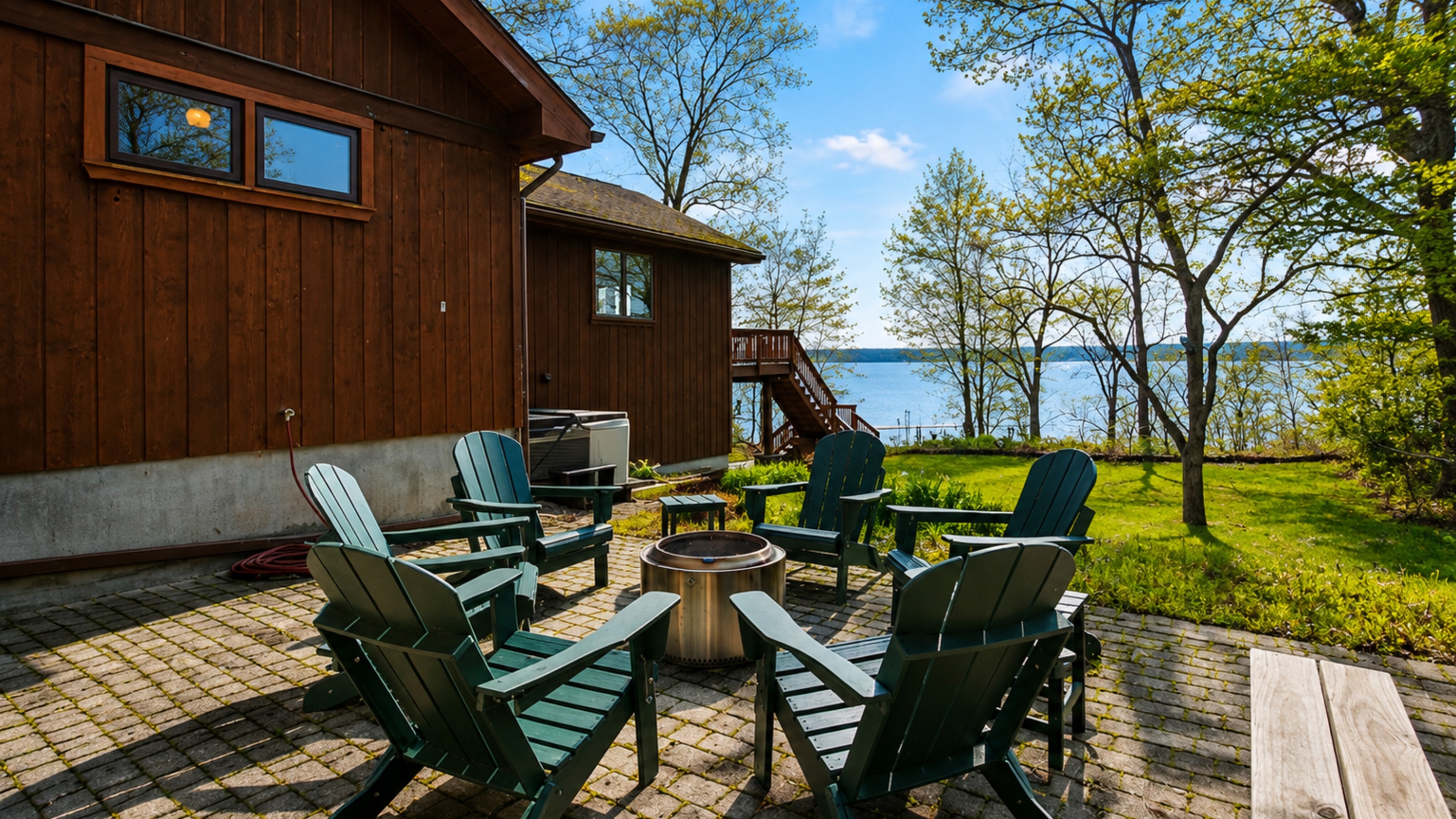 Fire Pit / Hot Tub (alongside the main house) - Gather around the fire pit in our scenic lakeside seating area for unforgettable evenings under the stars. Perfect for cozy gatherings. 