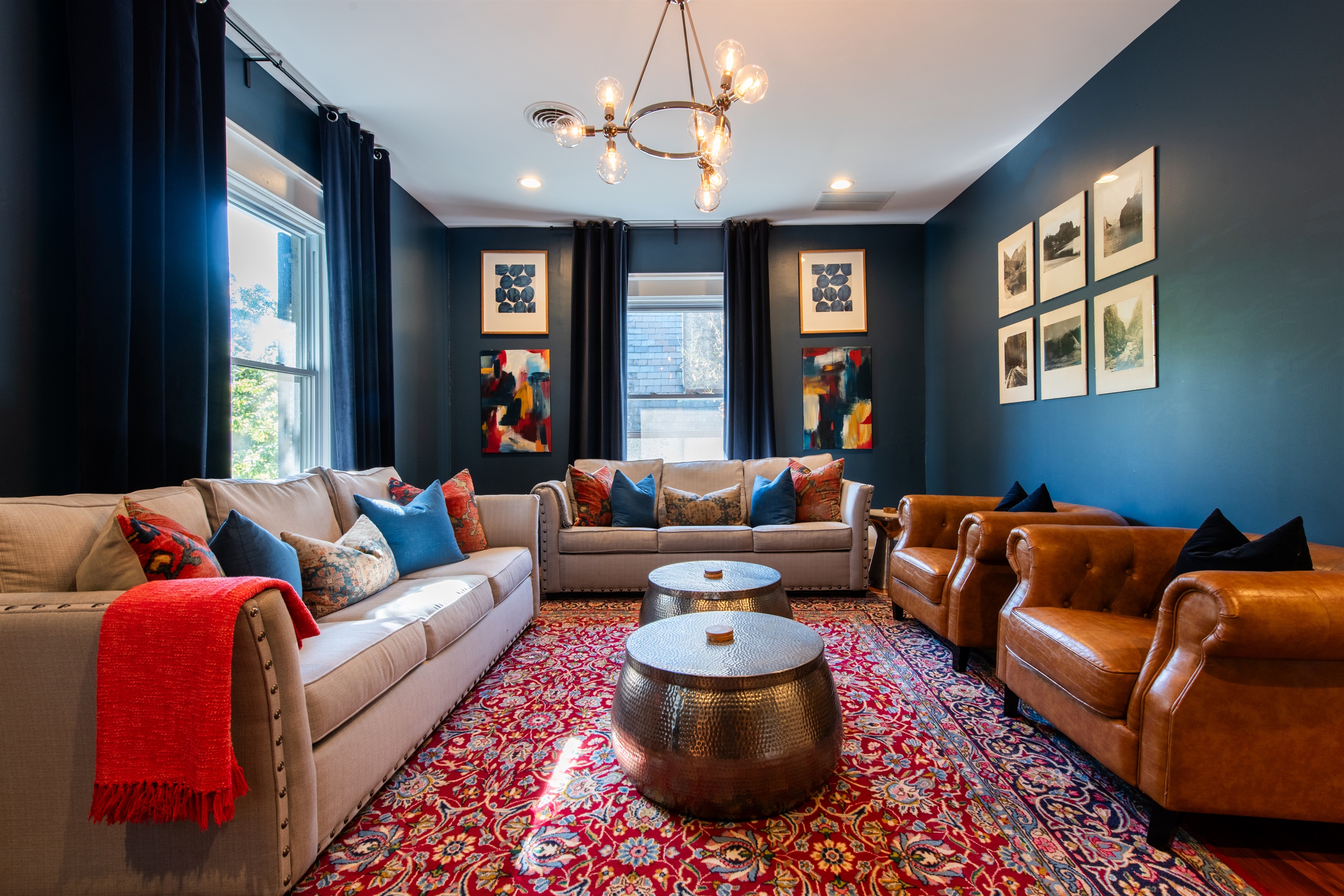 Gather in the sophisticated living room on the Bourbon Trail in Louisville’s Highlands! Plush leather chairs, cozy sofa, vibrant art, & a chic chandelier, ideal relaxing after distillery tours