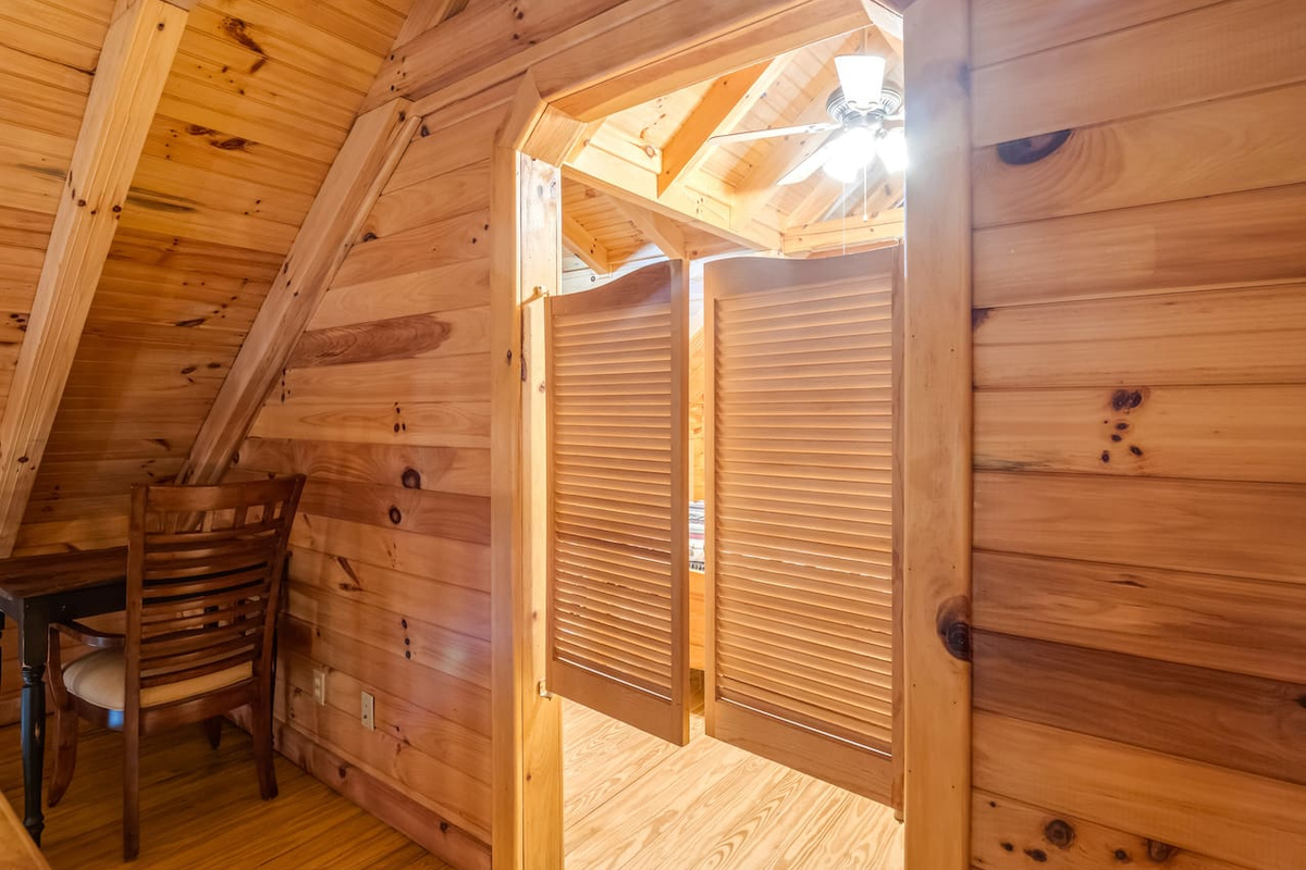 Additional view of upstairs loft, showcasing a writing nook and saloon doors leading to upstairs bedroom