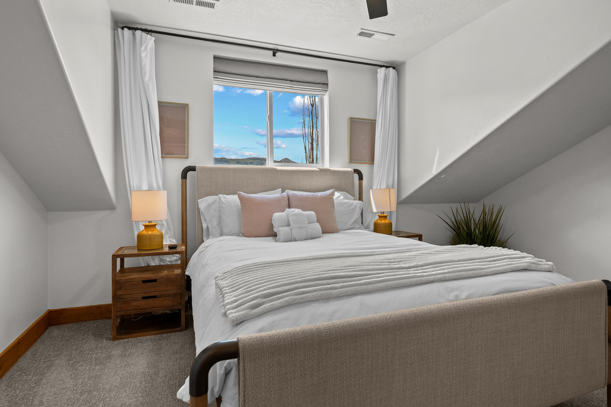 Comfortable bedding and soft neutral tones create an inviting place to rest after a full day outside.