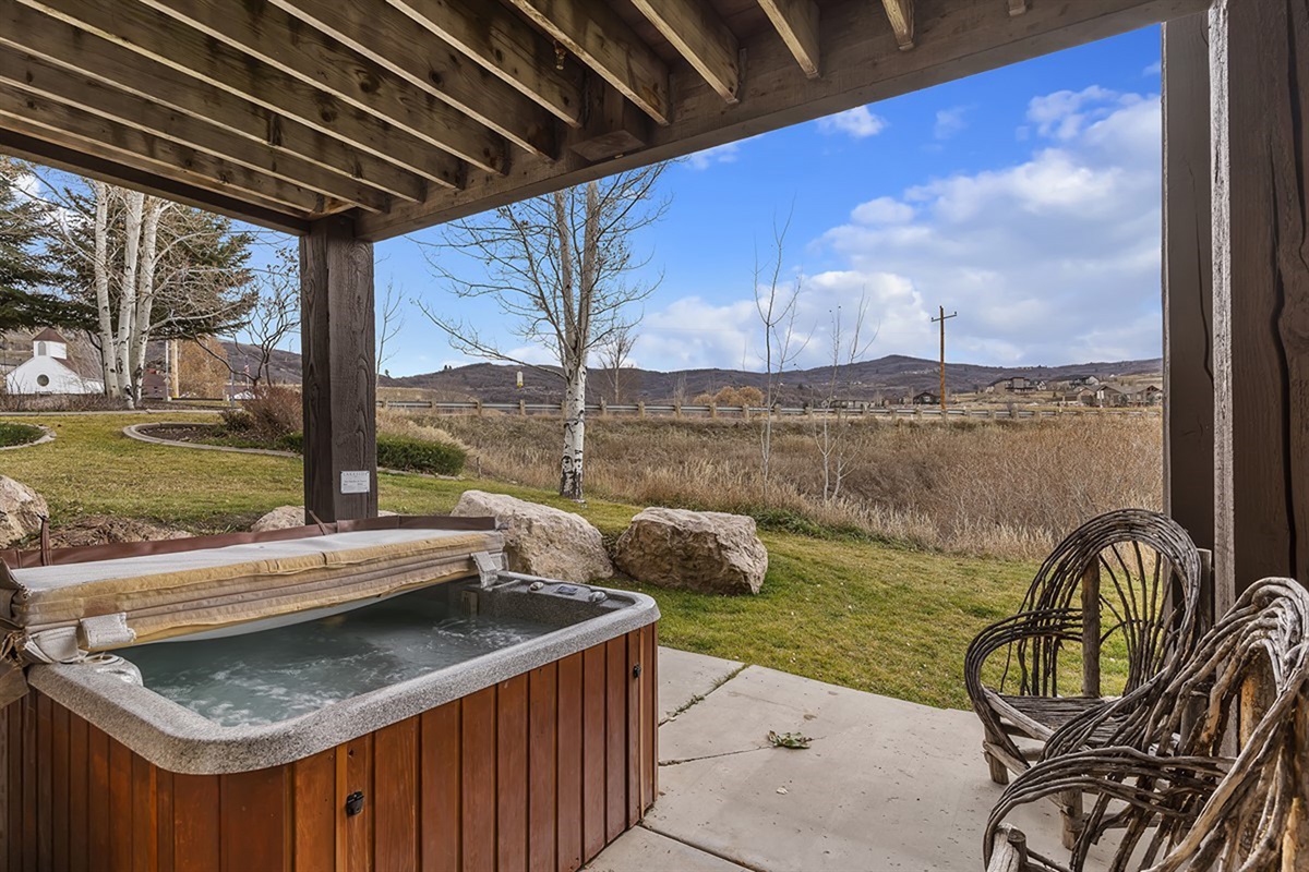 Unwind in your private hot tub beneath a covered patio, where open mountain views and peaceful surroundings create a true mountain retreat.