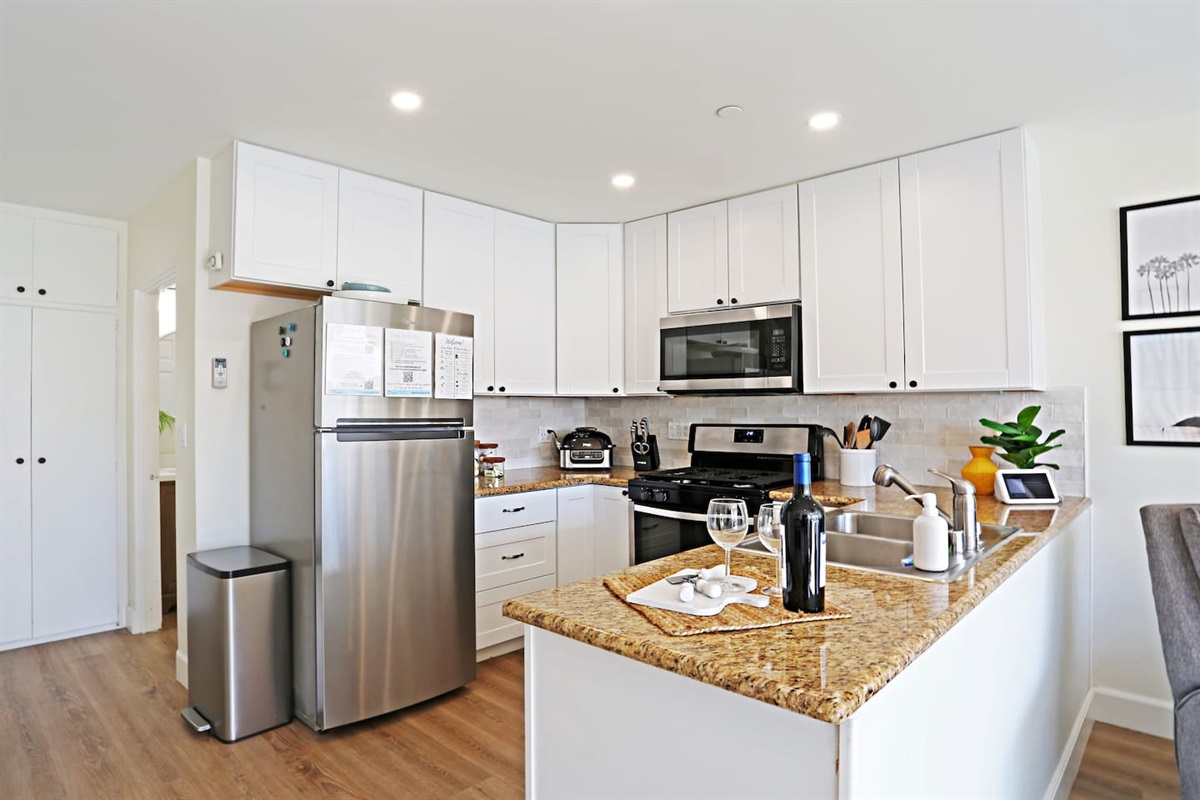 The bathroom is located down the short hallway next to the fridge