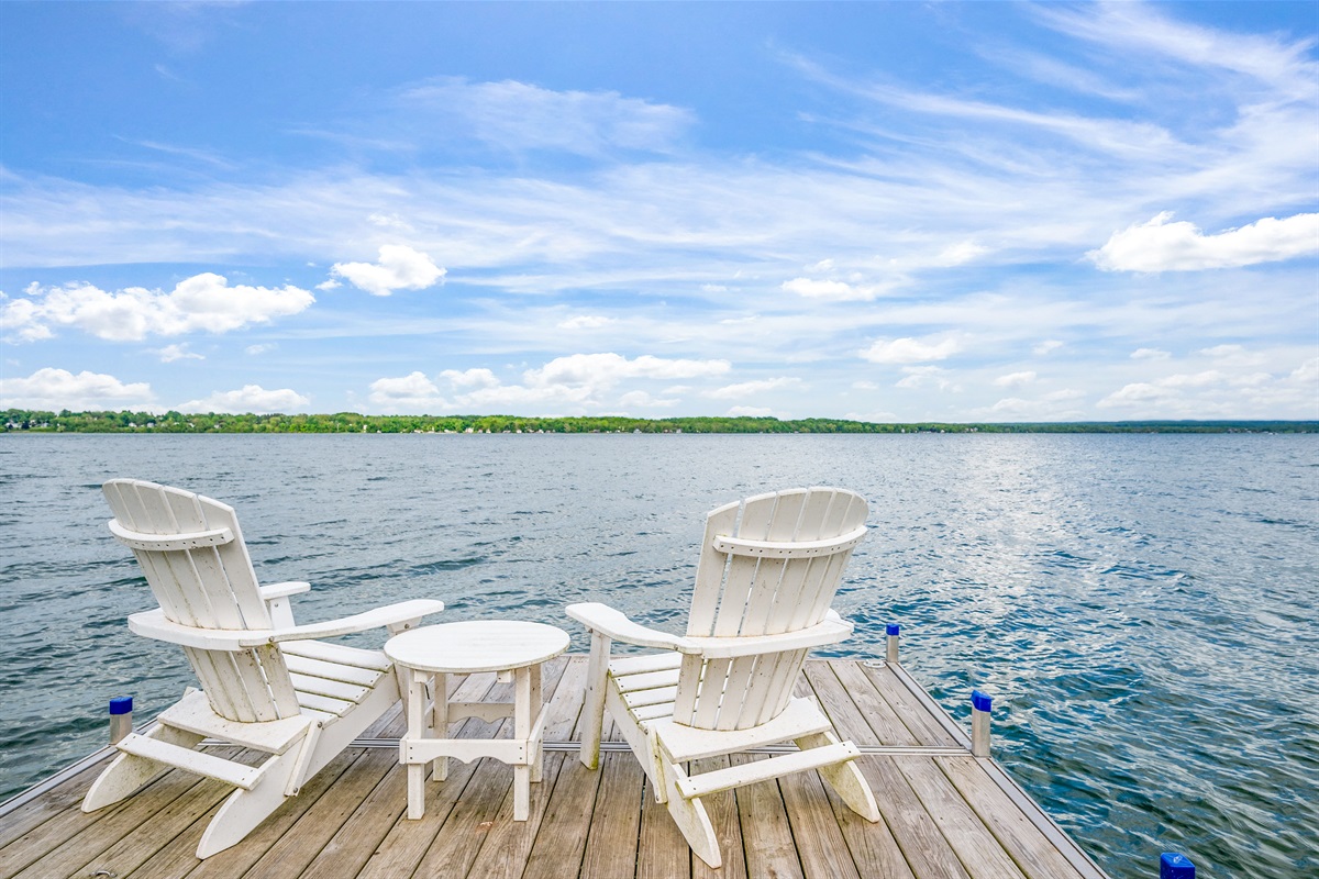 Unwind in classic Adirondack chairs with panoramic lake views and total tranquility.