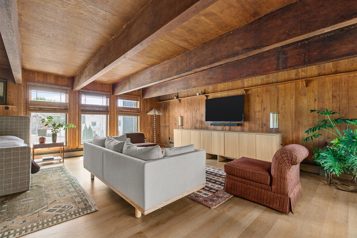 The primary bedroom doubles as a private retreat, with a cozy seating area and TV where you can relax, recharge, or sneak away for quiet time.