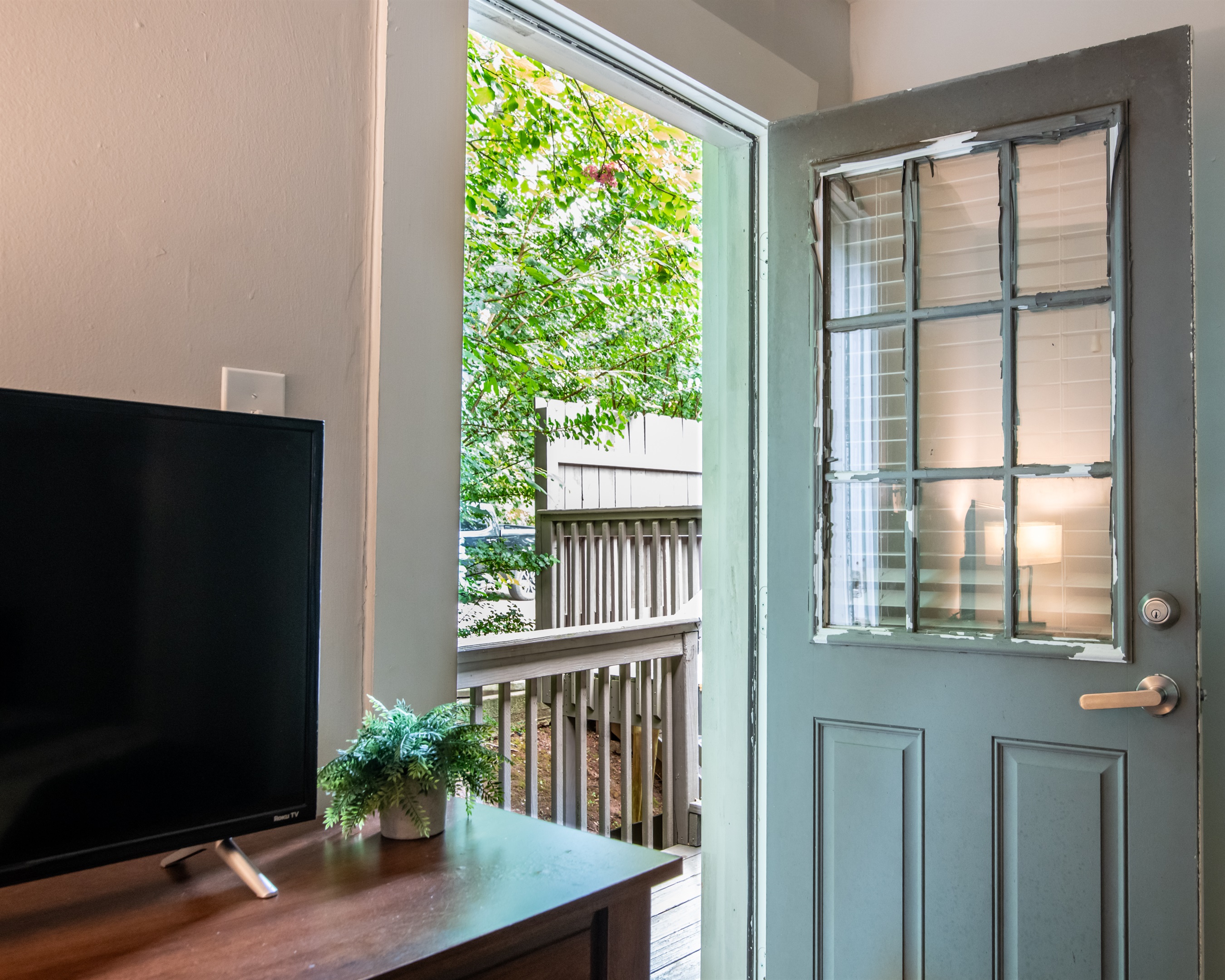 Private entryway with access to a small outdoor seating area — perfect for morning coffee.  