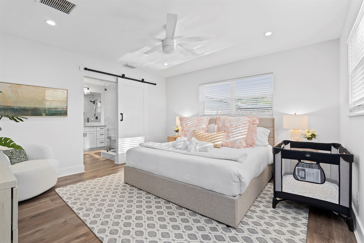 Retreat to the serene primary suite, where soft natural light, calming décor, and luxurious comfort create the ultimate place to recharge.