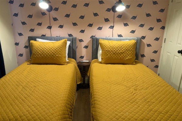 Stylish wallpaper detail in the second bedroom, with access to closet storage and a sound machine to help ensure a quiet night’s sleep.