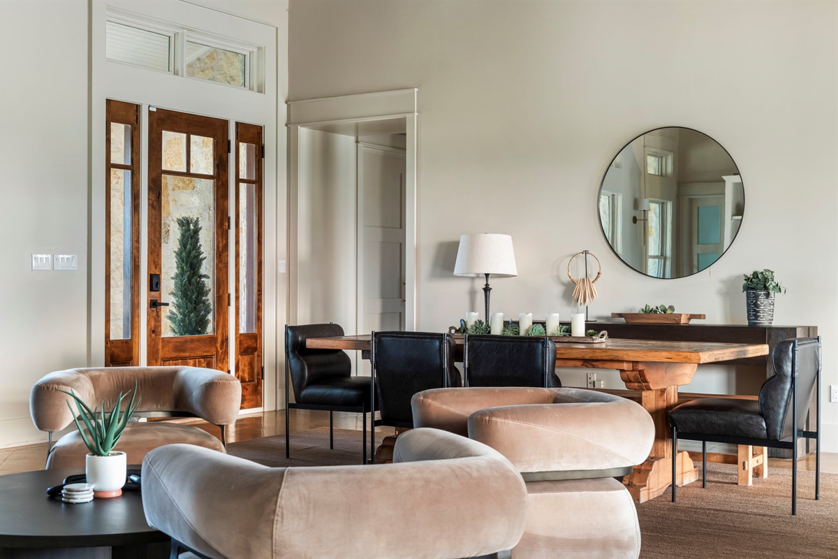 A captivating round mirror reflects the light and adds a touch of modern elegance to this inviting living space.