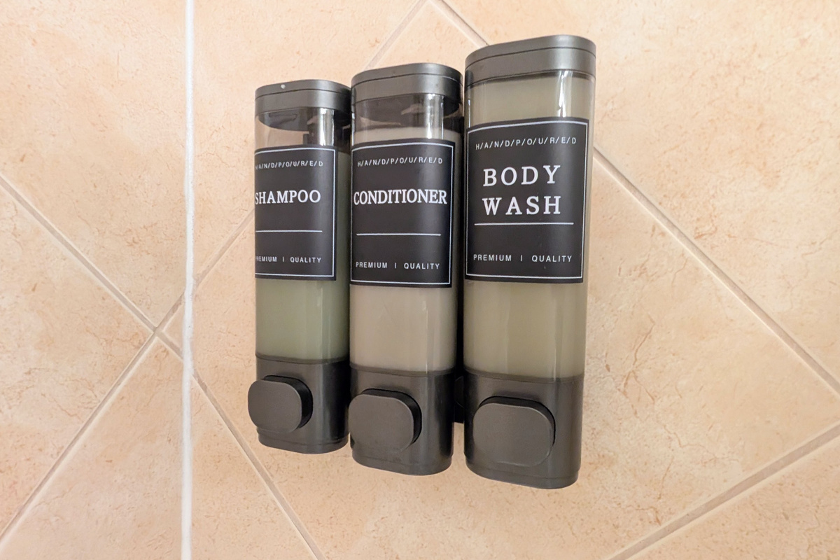 Shampoo, conditioner, and body wash are within easy reach in each shower.