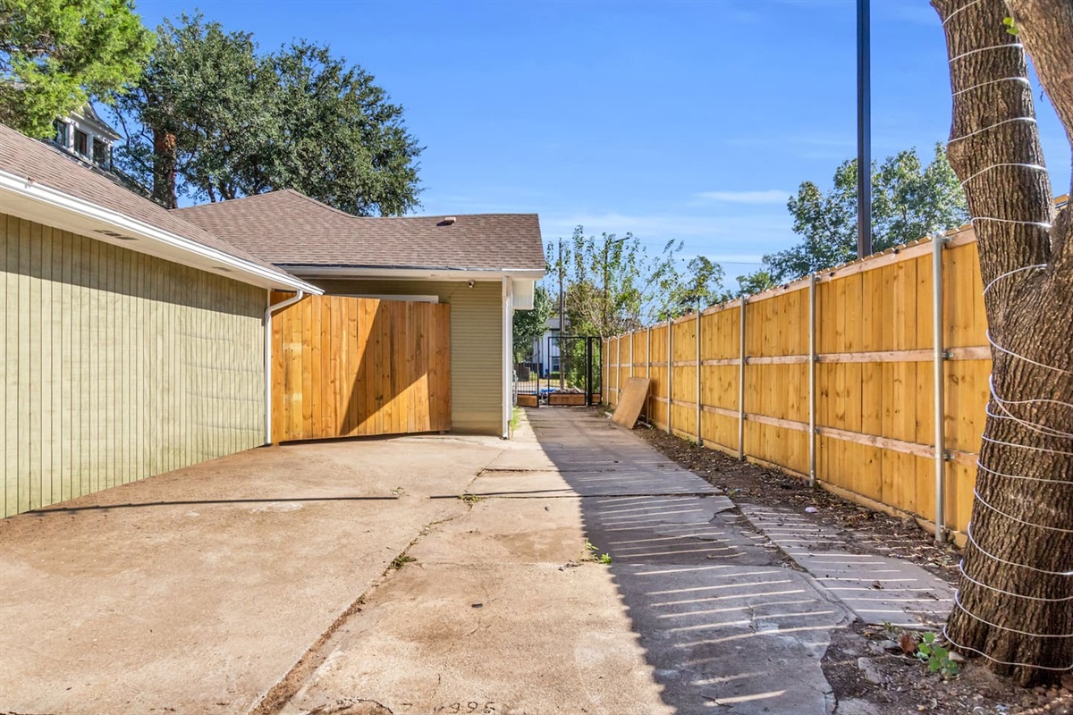 Enjoy free parking on premises with this private, gated driveway that fits two vehicles, well-lit with motion-activated lights for secure and easy access day or night.