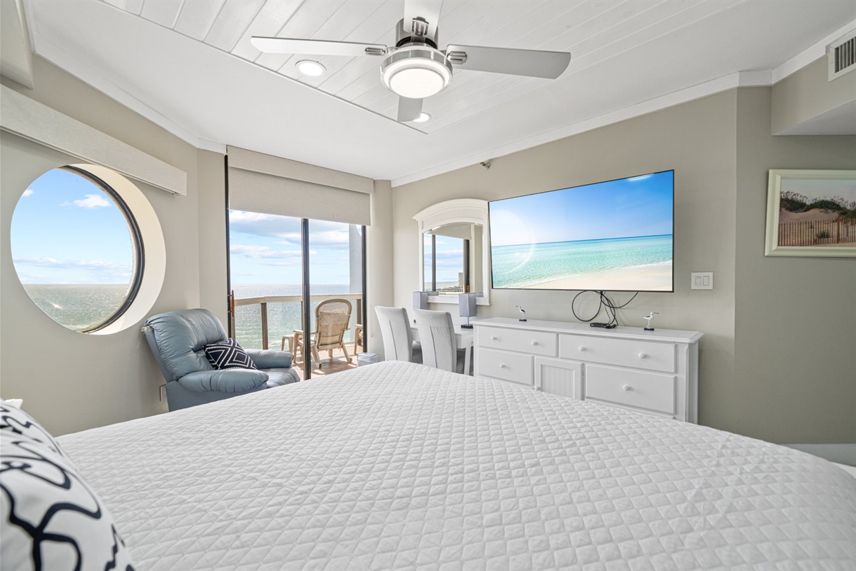 This is what it looks like to wake up Gulf-front on the 11th floor. Sparkling emerald water through the porthole, a king bed positioned so this view greets you every single morning, and the full Gulf glittering through the balcony slider just steps away.