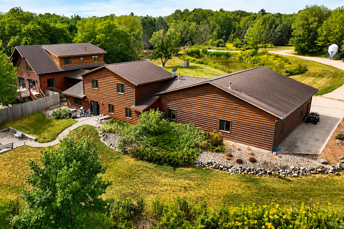 Beautiful aerial view of the lodge and surrounding Northwoods property, highlighting the spacious grounds, easy access, outdoor gathering areas, and room for your group to enjoy a true Wisconsin getaway.