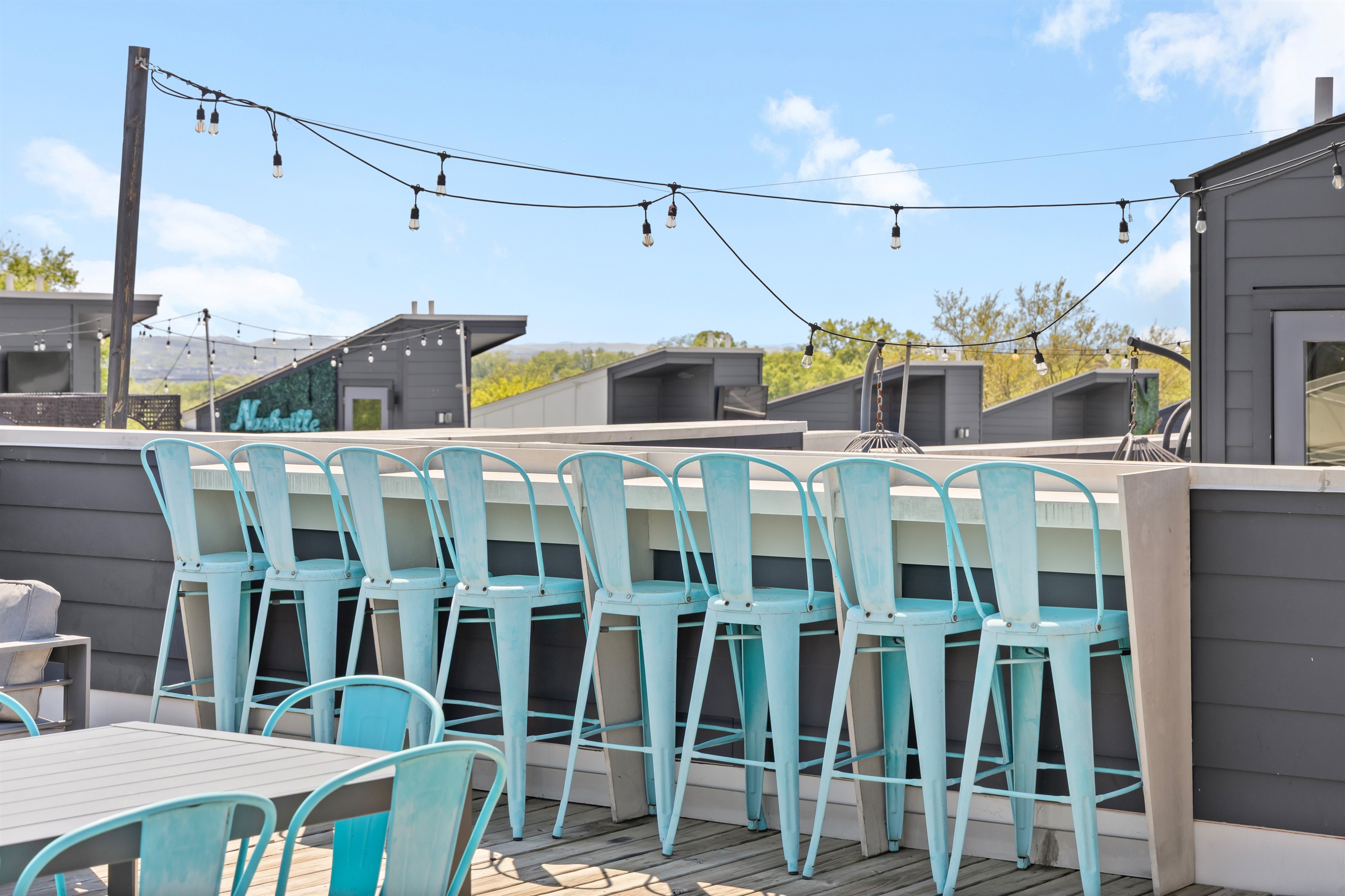 Rooftop Oasis: Sip cocktails at the bar with stunning views and twinkling string lights!