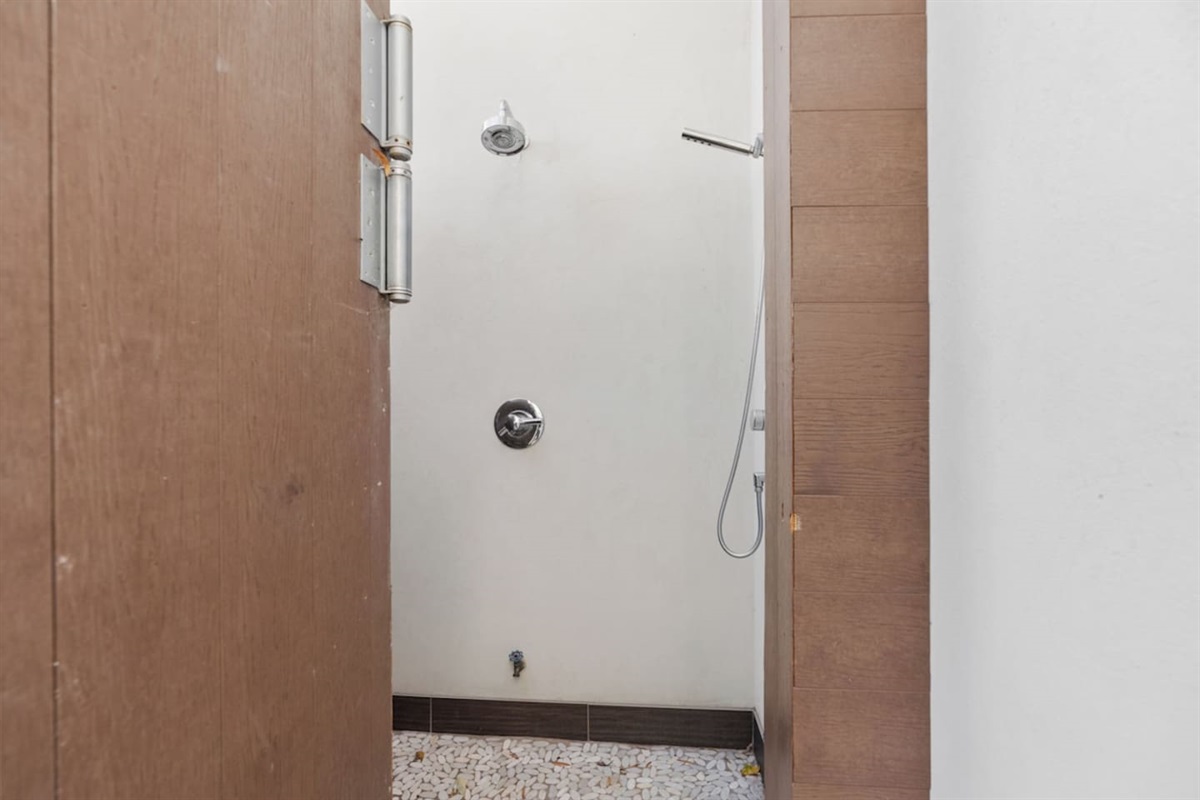 Outdoor shower just steps away from the pool located on the patio.