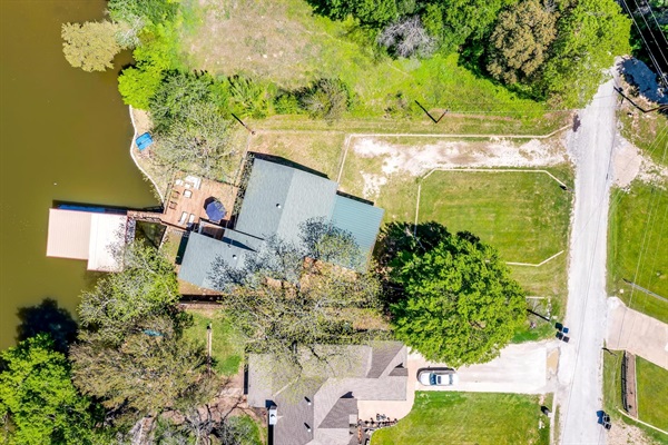 Top-down aerial showcasing private dock, canal frontage, and spacious yard.