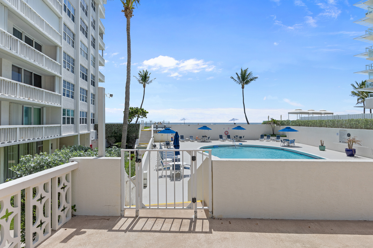 Your backyard. Heated pool, lounge chairs, and blue skies — 30 seconds from your front door.