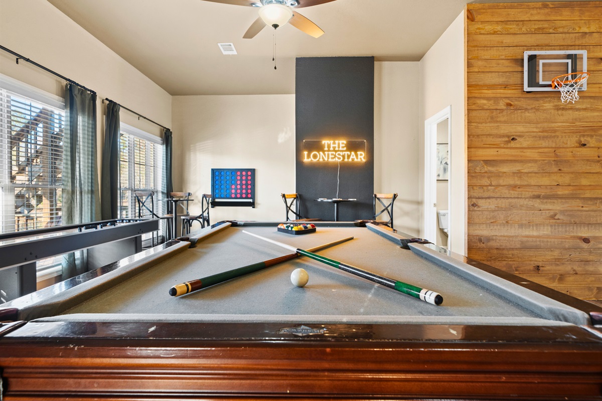 A classic pool table enhances the laid-back atmosphere and invites everyone to jump into a friendly game.