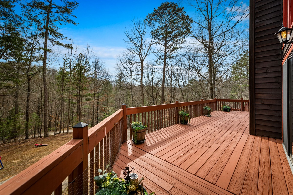 The outdoor deck provides a spacious area to relax while taking in scenic views of the surrounding landscape.