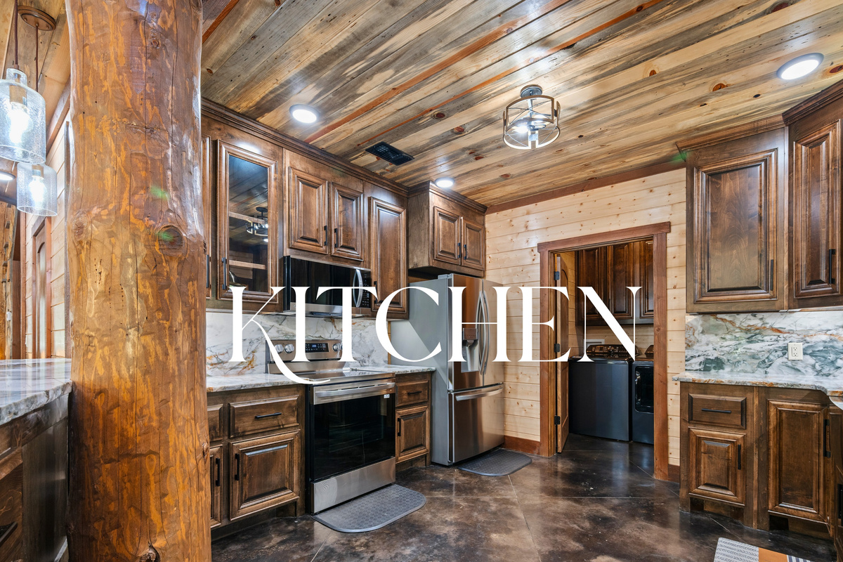 Fully equipped kitchen with stainless appliances and wood cabinetry.