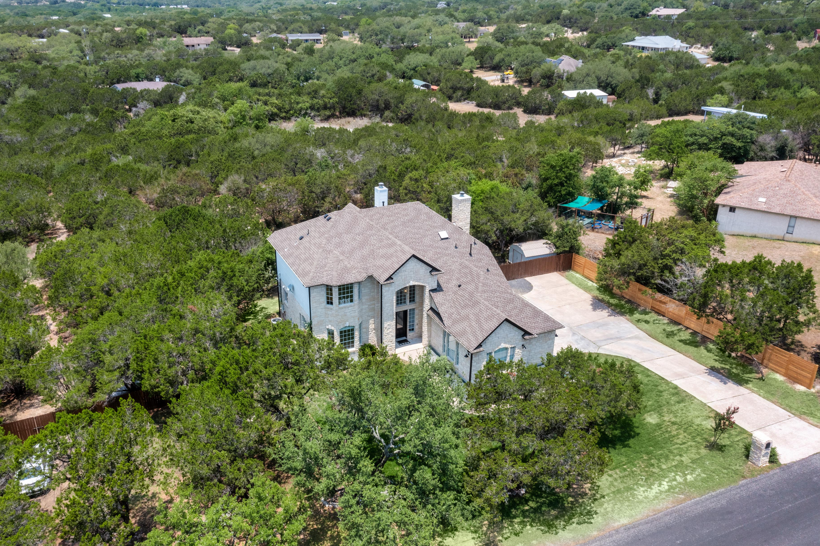 Tucked among the trees — a private Hill Country retreat from above.