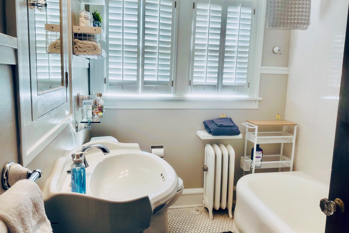 Full bath, upstairs, conveniently located near all three upstairs bedrooms. This bath includes many shelves and a spacious medicine cabinet.