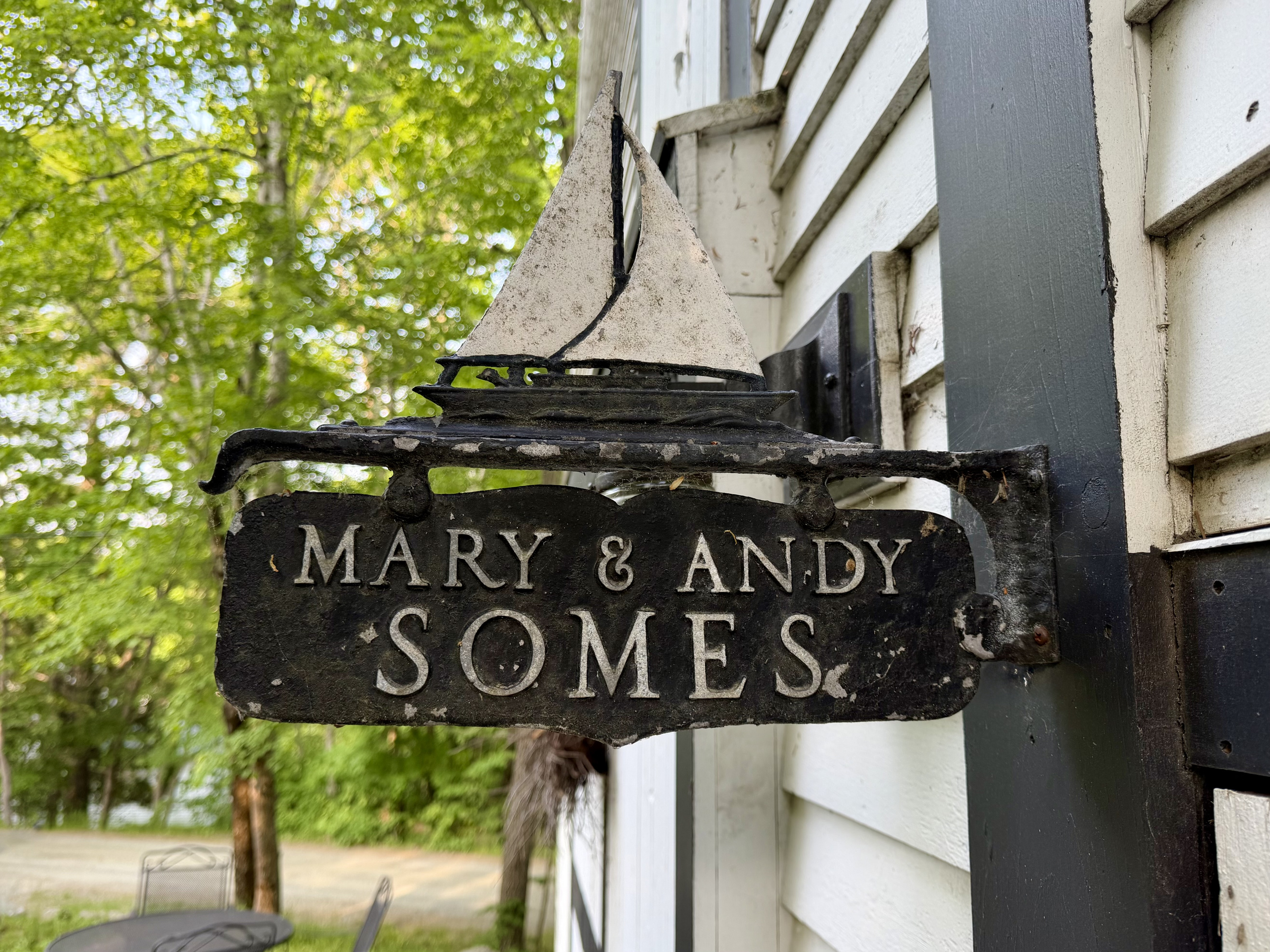 A historic nod at the entrance to the Settler's Sidecar. This antique sign honors the Somes family—the original founders of Somesville who still proudly own this home today. Stay in a true, unaltered piece of Mount Desert Island heritage.