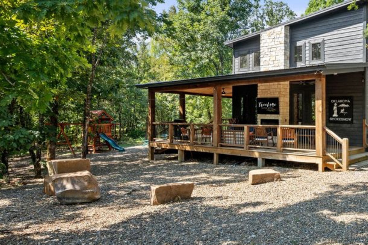 Back porch with fireplace and views of the playset.