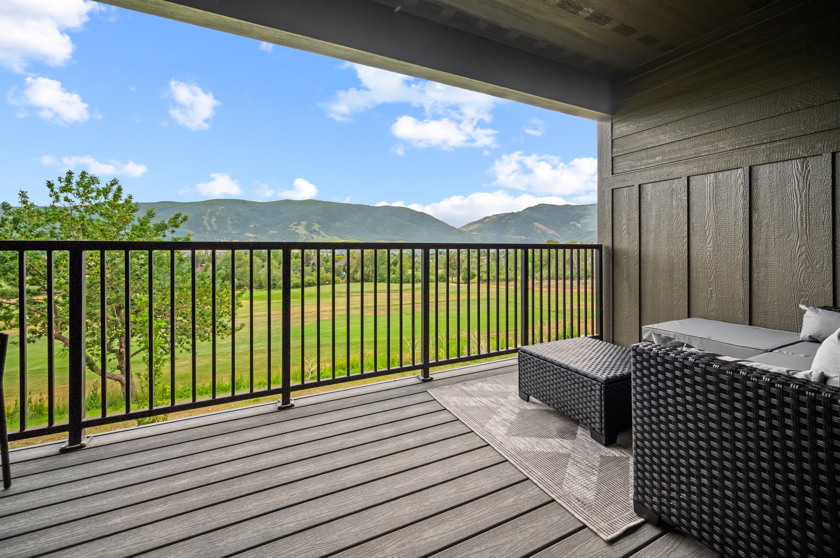 Step out from the bedroom onto a private deck with cozy seating for morning coffee or evening relaxation.
