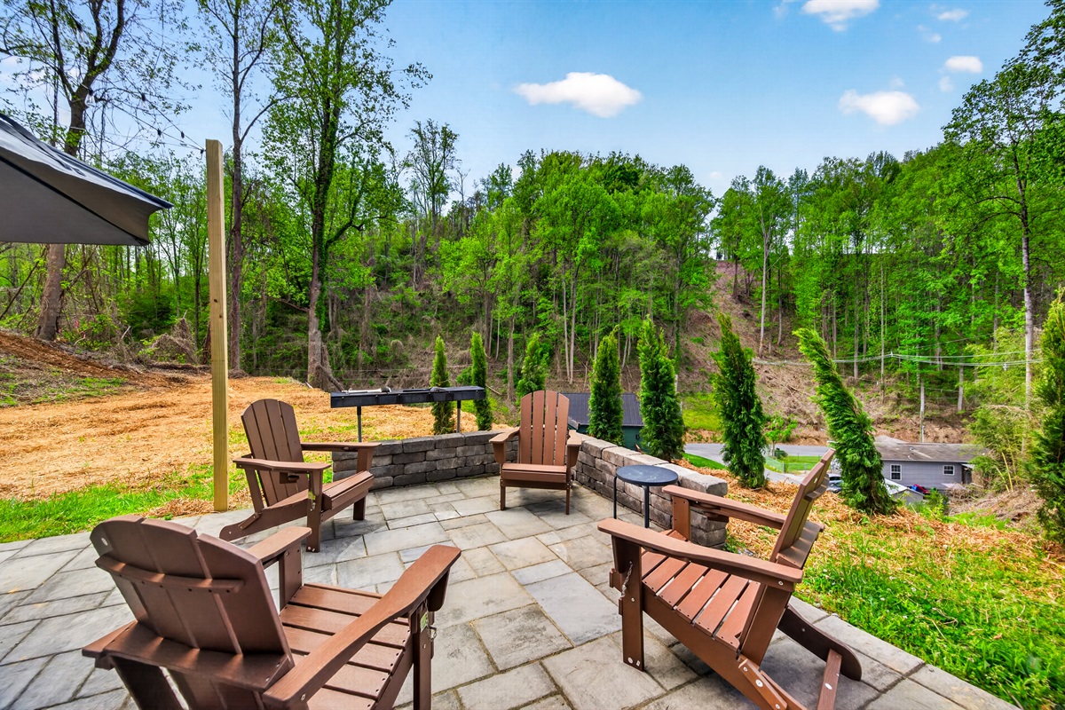 Outdoor seating area with charcoal grill.