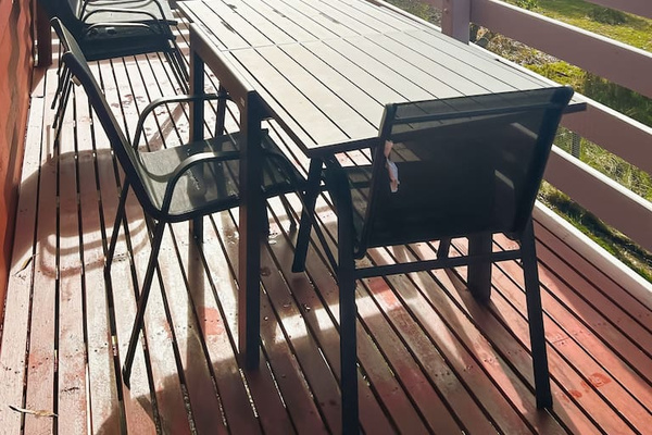 The upstairs balcony at Carlenes Getaway gives you a quiet leafy spot to sit outside during your Loch Sport stay.